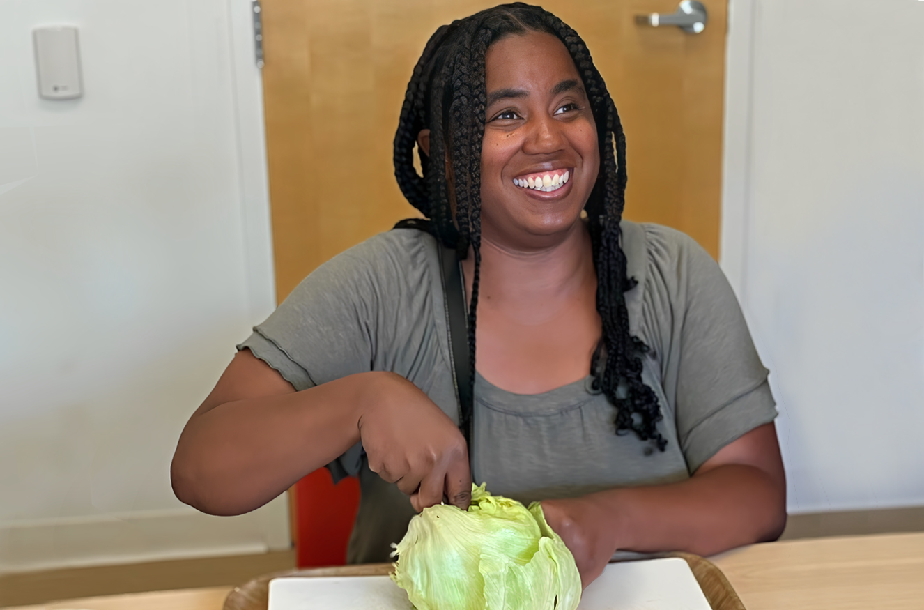 Woman cutting lettuce and smiling